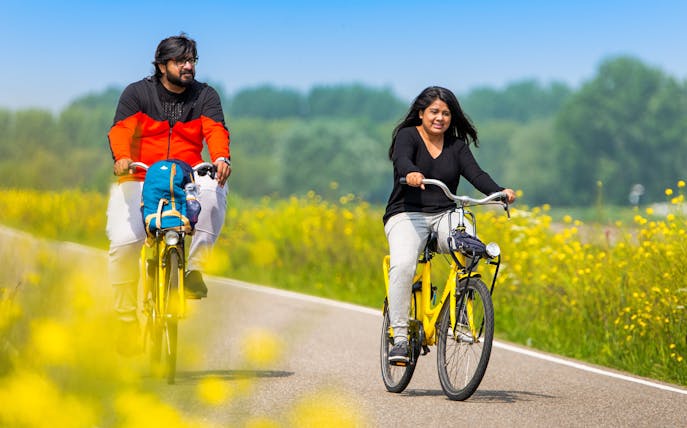 Cyclists on a countryside path near Amsterdam during a half-day bike tour.