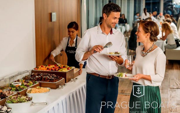 Couple enjoying buffet on Prague by Night Dinner Cruise.