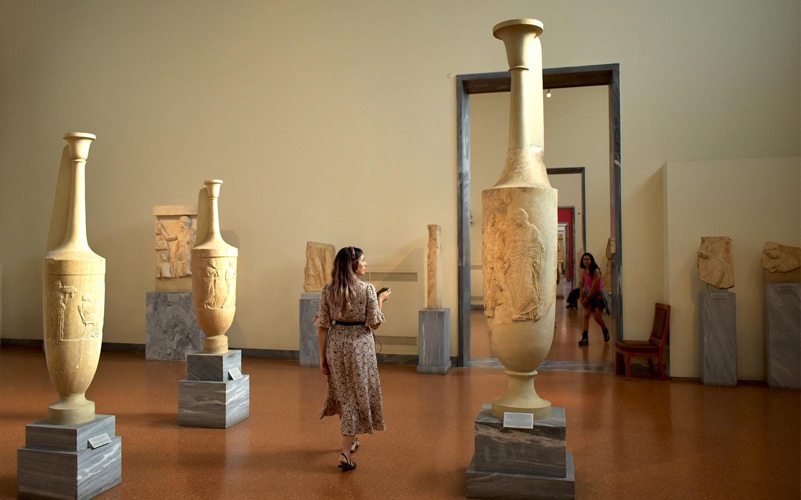 Visitor exploring ancient artifacts at the National Archaeological Museum.