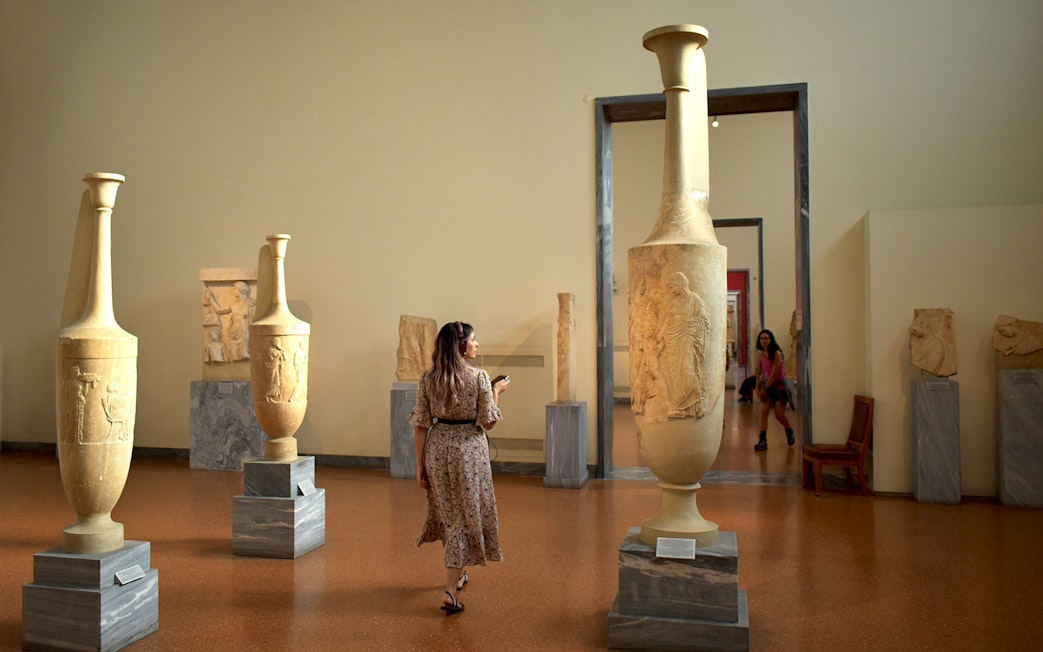 Visitor exploring ancient artifacts at the National Archaeological Museum.