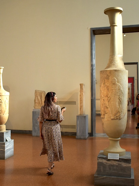 Visitor exploring ancient artifacts at the National Archaeological Museum.