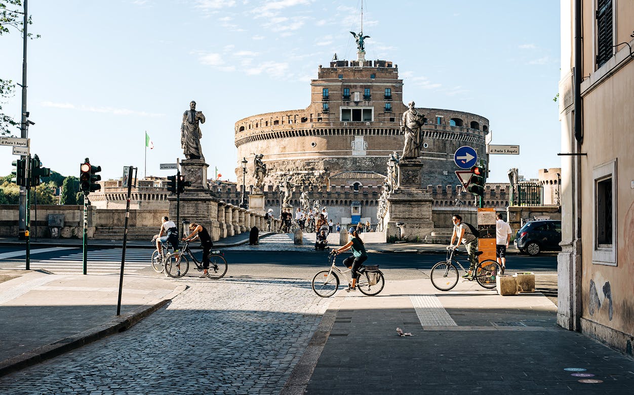 Cyclists near Castel Sant'Angelo in Rome, part of the Angels and Demons Experience.