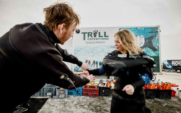 Tour participants preparing for snorkeling in Silfra, Iceland, with Troll Expeditions.