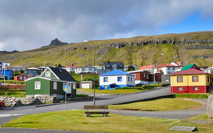 Colorful houses in a village on the Snaefellsnes Peninsula, Iceland, with a mountain backdrop.