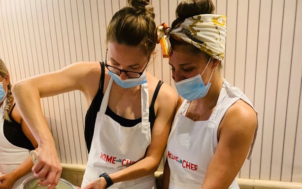 Participants in a cooking class making pasta in Rome.
