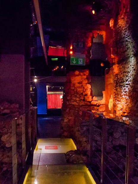 Rynek Underground Museum corridor with illuminated stone walls in Kraków.