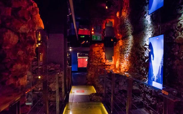 Rynek Underground Museum corridor with illuminated stone walls in Kraków.