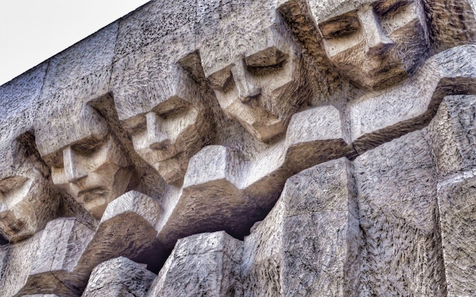 Stone relief of faces at Plaszow Concentration Camp memorial, Krakow.
