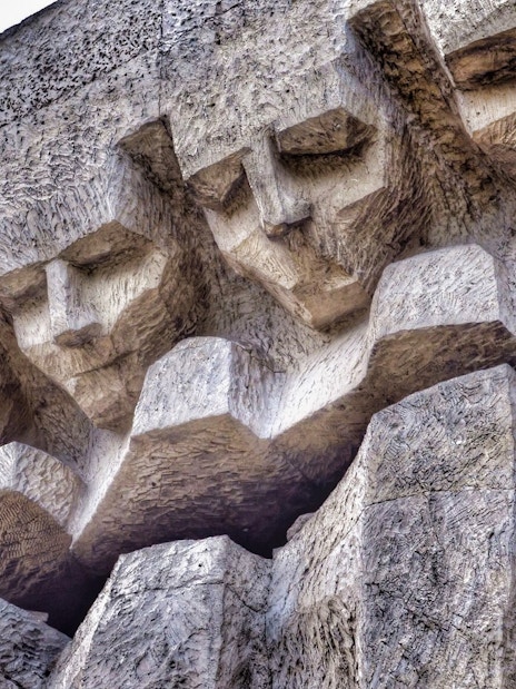 Stone relief of faces at Plaszow Concentration Camp memorial, Krakow.