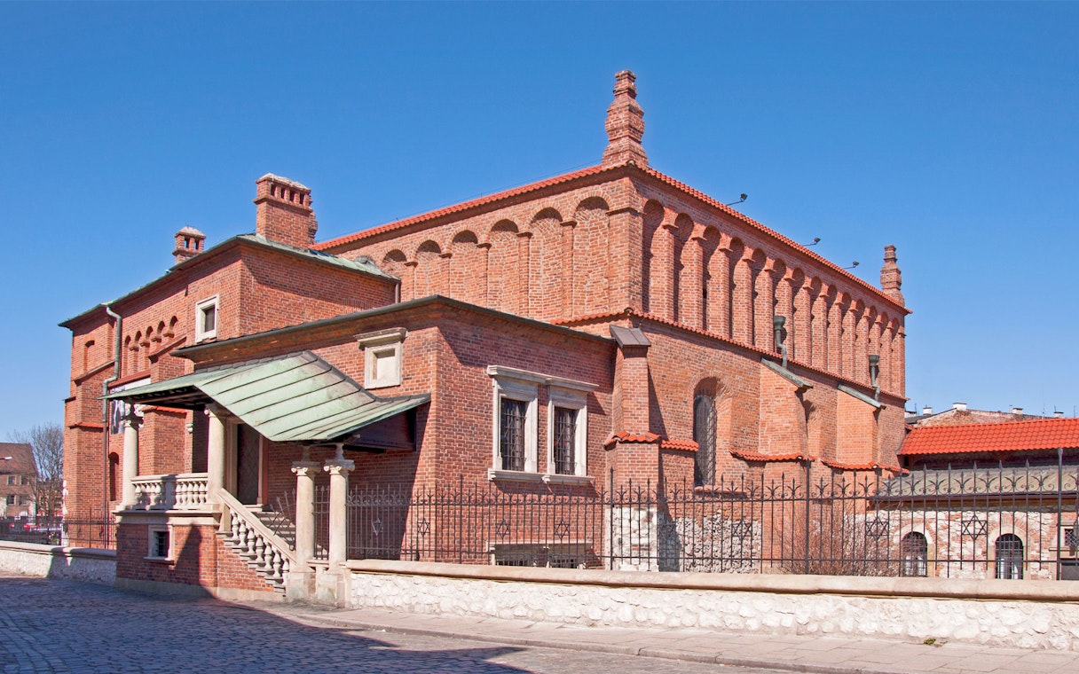 Synagogue in Jewish Quarter Kazimierz, Krakow, featuring red brick architecture.