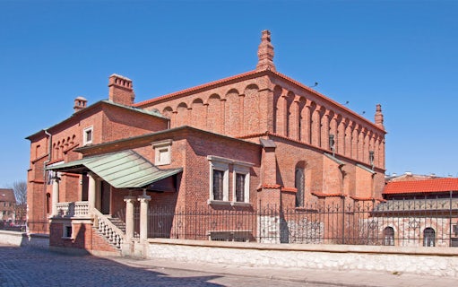 Synagogue in Jewish Quarter Kazimierz, Krakow, featuring red brick architecture.