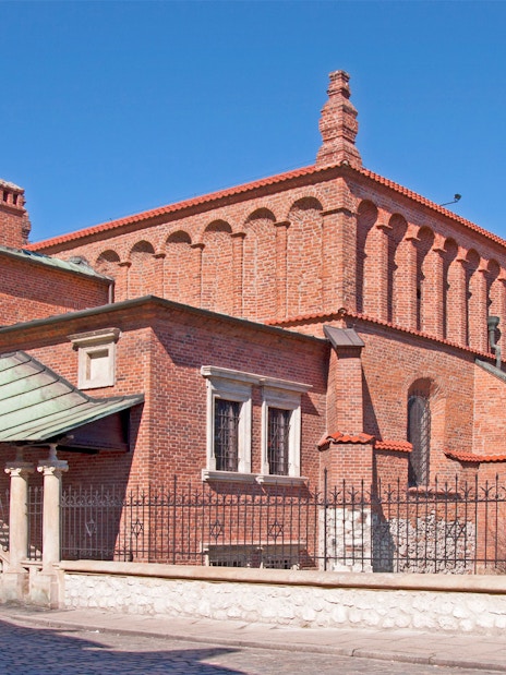Synagogue in Jewish Quarter Kazimierz, Krakow, featuring red brick architecture.