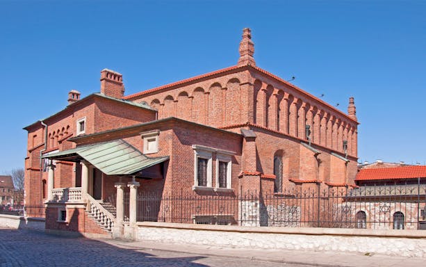 Synagogue in Jewish Quarter Kazimierz, Krakow, featuring red brick architecture.