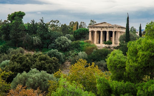 Ancient Agora in Athens with Temple of Hephaestus surrounded by lush greenery.