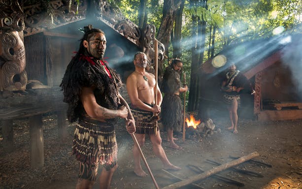 Maori performers in traditional attire at Tamaki Maori Village, New Zealand.