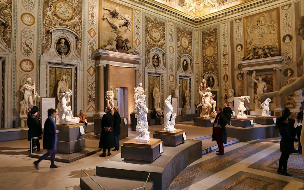 Borghese Gallery interior with sculptures and visitors, Rome.