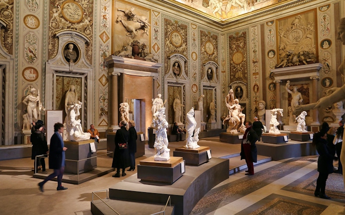 Borghese Gallery interior with sculptures and visitors, Rome.
