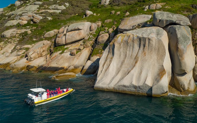 Boat tour near rocky cliffs at Wilsons Promontory, Australia.