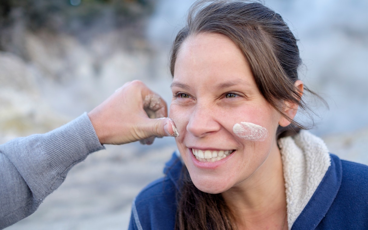 Person enjoying a mud facial at Hell's Gate geothermal park.