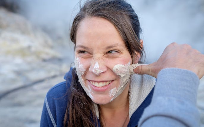 Woman enjoying a mud facial at Hell's Gate Thermal Experience.