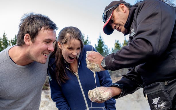 Visitors enjoying mud demonstration at Hell's Gate Thermal Experience, New Zealand.