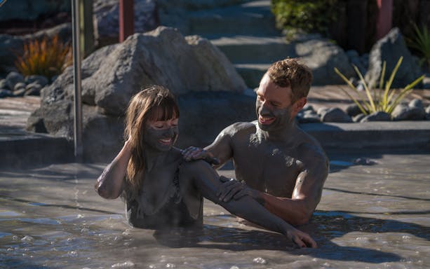 Couple enjoying a mud bath at Hell's Gate Spa.