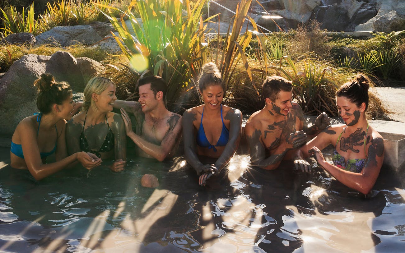 Group enjoying mud baths at Hell's Gate Sulphur Spas, New Zealand.