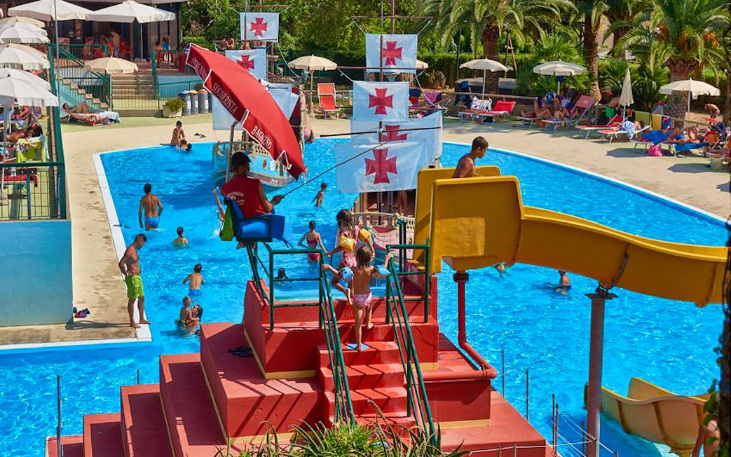 Children playing near a pirate ship slide at Caravelle Aquapark.