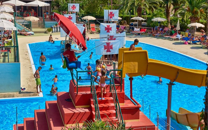 Children playing near a pirate ship slide at Caravelle Aquapark.