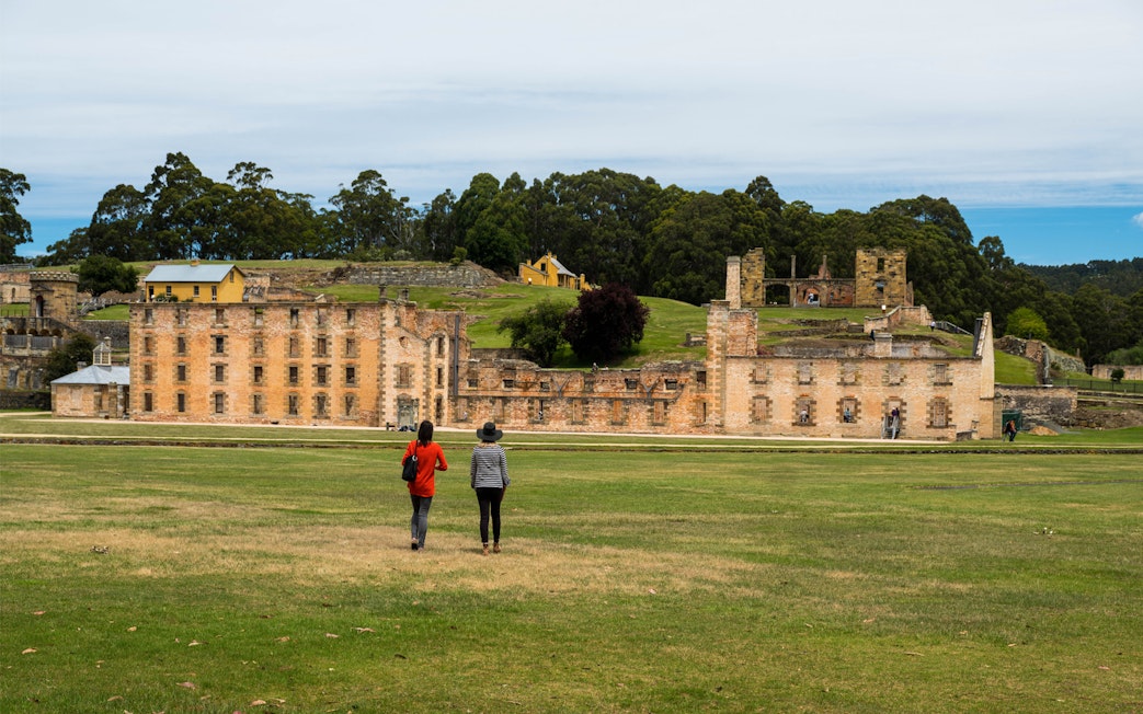 Visitors walking towards Port Arthur Historic Site, Tasmania.