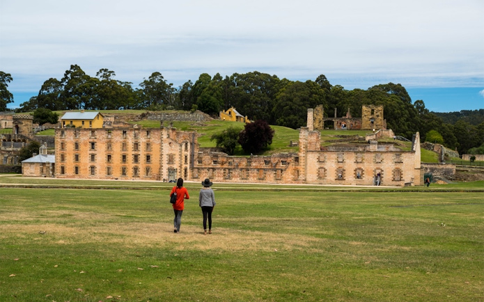 Visitors walking towards Port Arthur Historic Site, Tasmania.