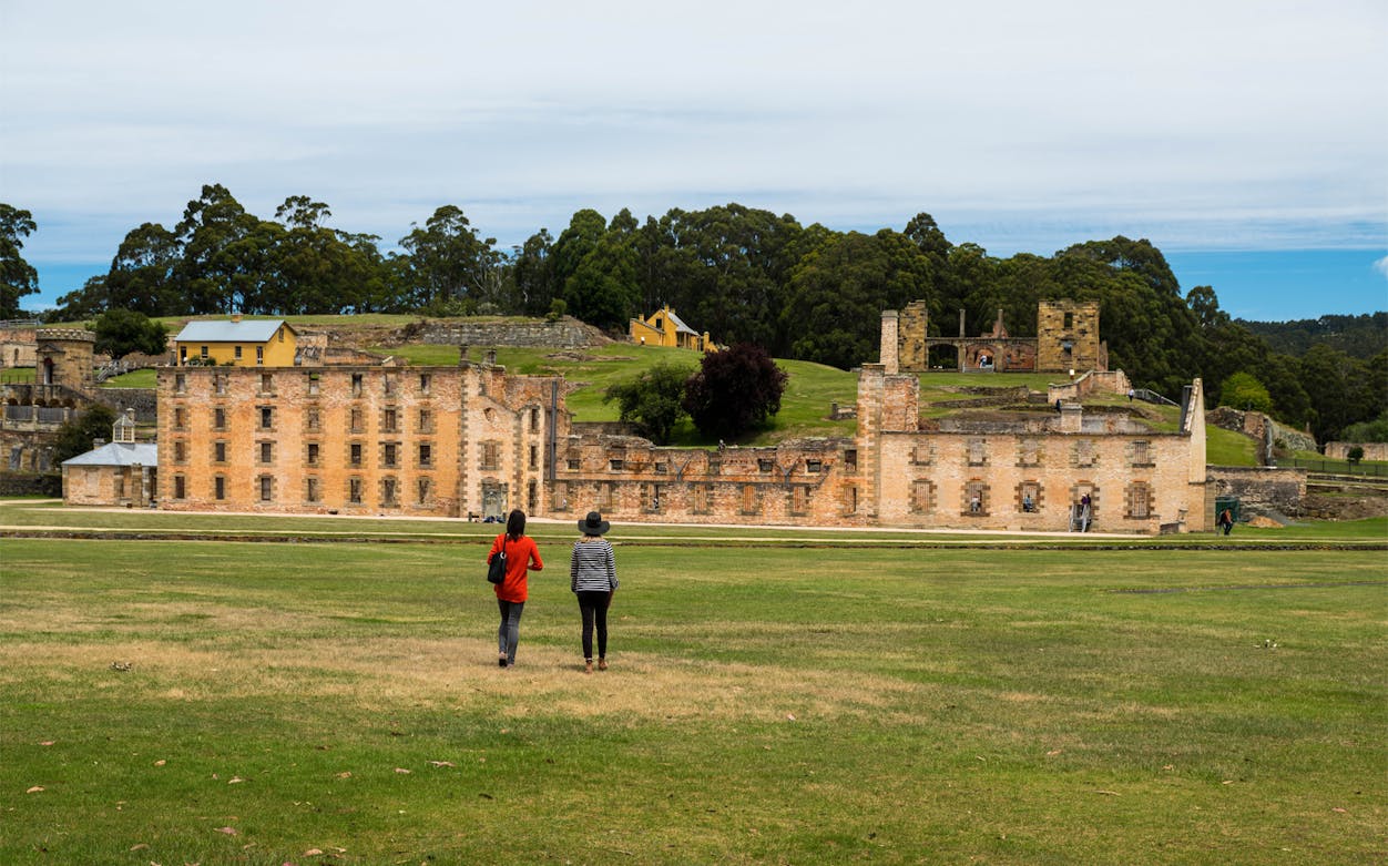 Visitors walking towards Port Arthur Historic Site, Tasmania.