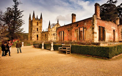 Port Arthur historic site with visitors exploring ruins, Hobart to Port Arthur bus service.