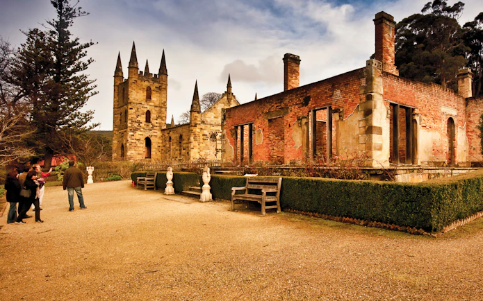 Port Arthur historic site with visitors exploring ruins, Hobart to Port Arthur bus service.