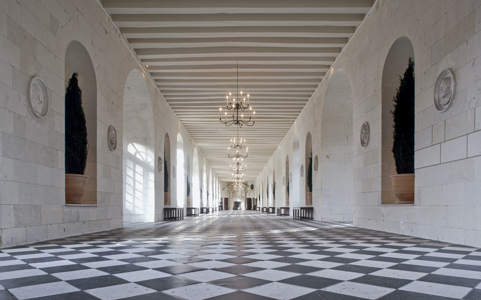 Grand hallway with checkered floor at Chenonceau Castle, France.