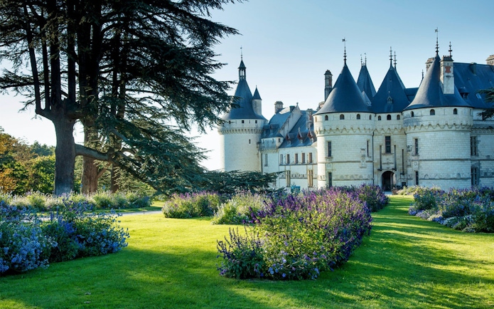 Chaumont sur Loire Castle with gardens and large trees in the foreground.