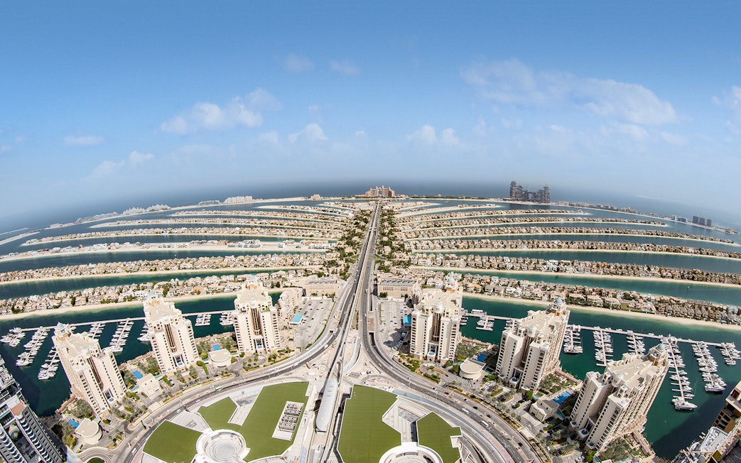 Aerial view of Palm Jumeirah in Dubai with luxury buildings and waterways.