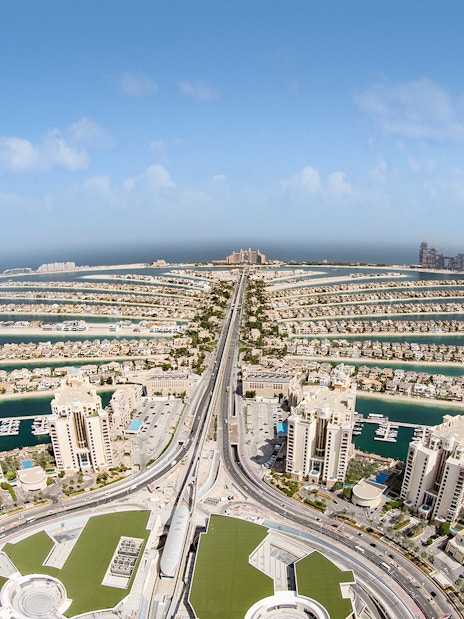 Aerial view of Palm Jumeirah in Dubai with luxury buildings and waterways.