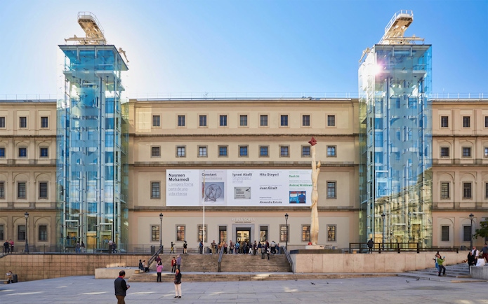 Reina Sofía Museum entrance with visitors in Madrid, Spain.