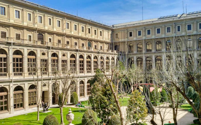Reina Sofia Museum courtyard with trees and historic architecture in Madrid.