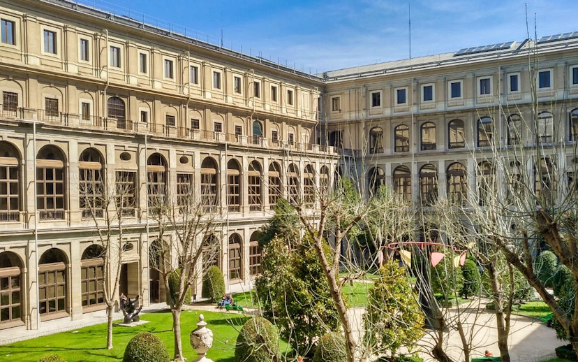 Reina Sofia Museum courtyard with trees and historic architecture in Madrid.