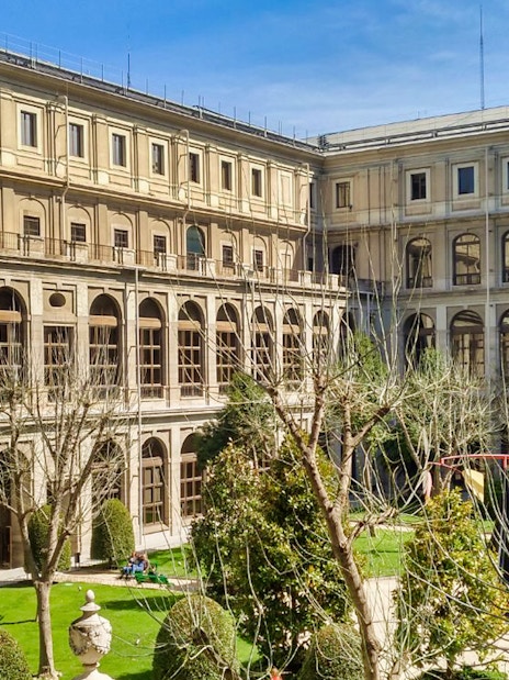 Reina Sofia Museum courtyard with trees and historic architecture in Madrid.