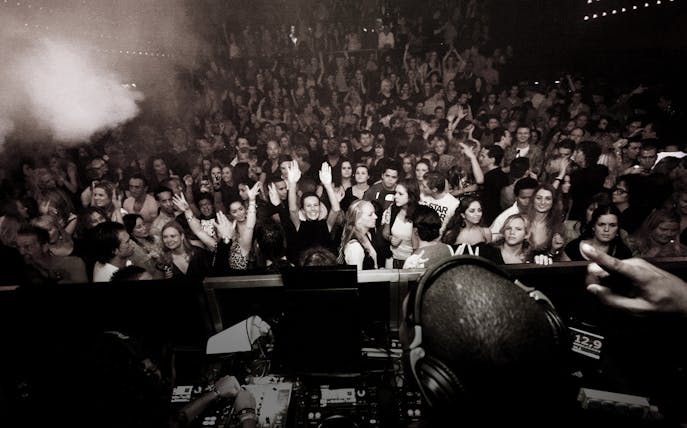 Crowd enjoying a DJ performance at a lively Amsterdam night event.