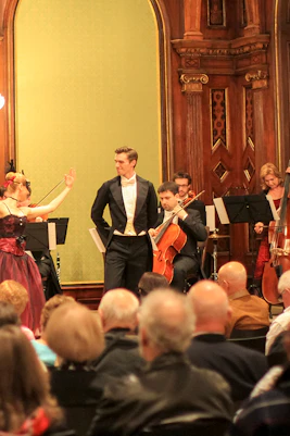 Musicians and dancers performing at Vienna Supreme Concerts in an ornate hall.
