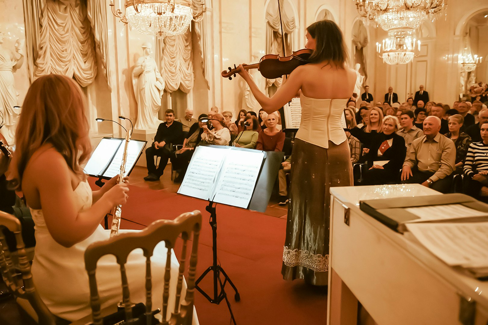 Musicians performing at Vienna Supreme Concerts with an audience in an elegant hall.