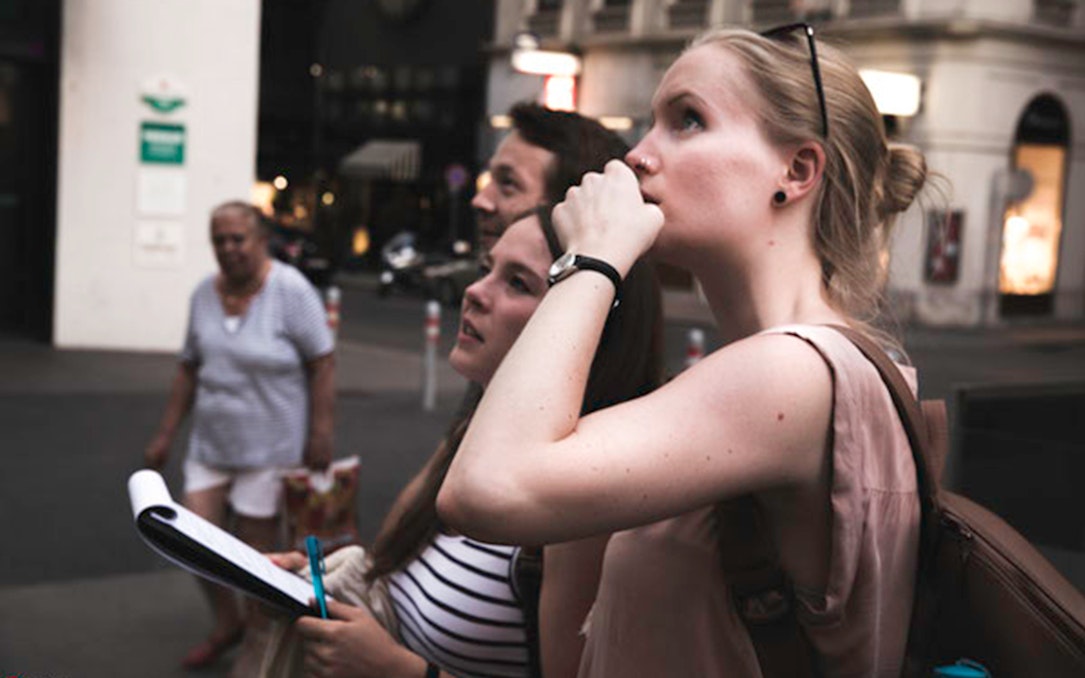 Participants on a Vienna ghost tour with a treasure hunt map.