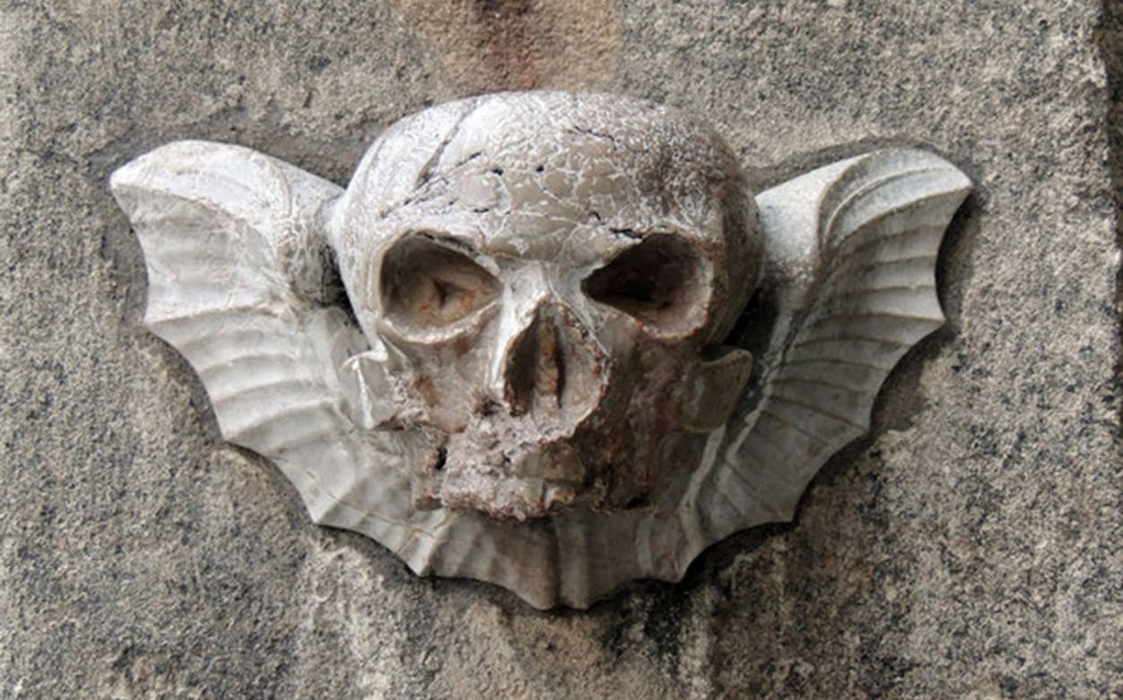 Stone skull carving with wings on a Vienna building, part of the 2-Hour Ghost Tour.