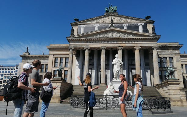 Tourists exploring Konzerthaus Berlin during a guided walking tour.