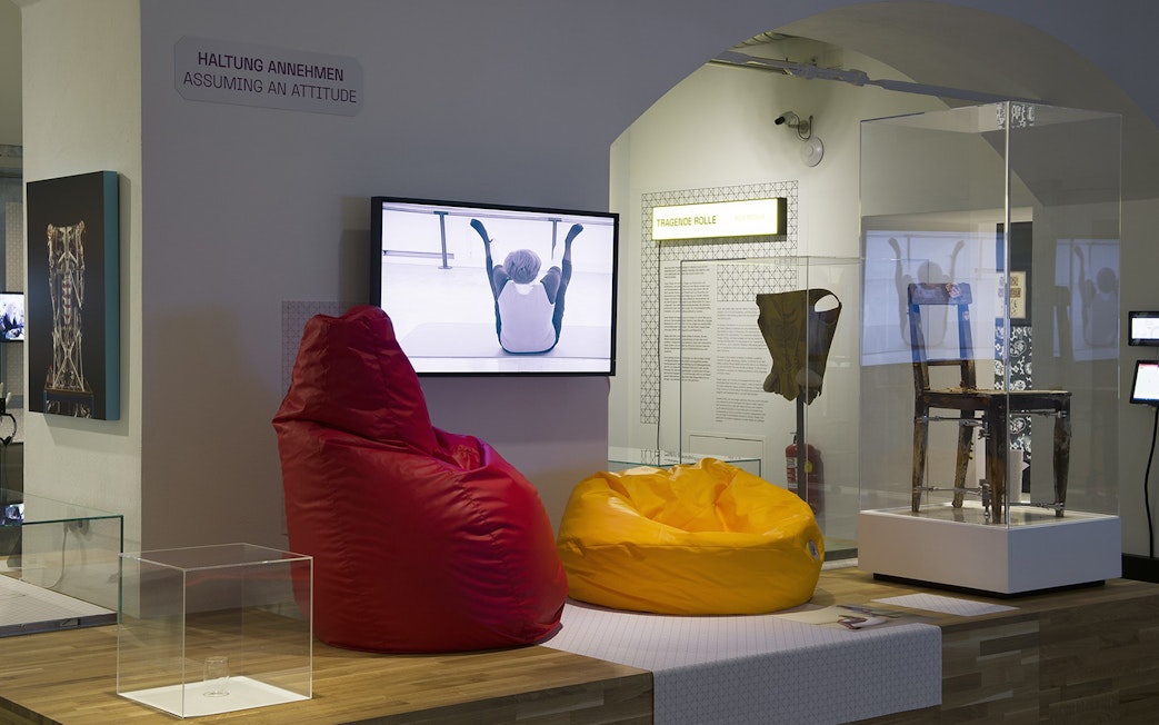 Visitors exploring MAK Museum of Applied Arts Vienna interior exhibit with modern seating.