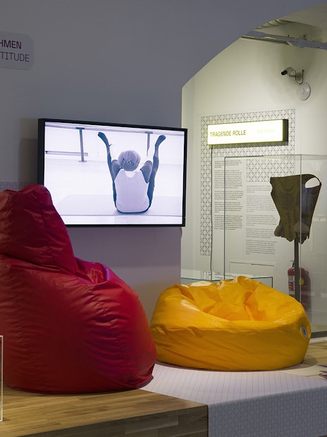Visitors exploring MAK Museum of Applied Arts Vienna interior exhibit with modern seating.